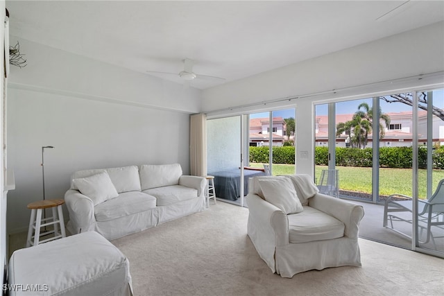 living room with ceiling fan and light colored carpet