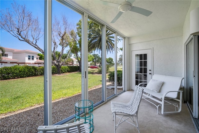 sunroom with a wealth of natural light and ceiling fan