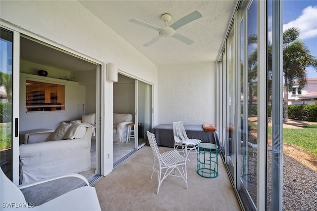 sunroom / solarium featuring ceiling fan