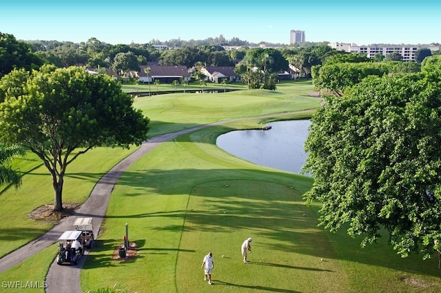 surrounding community featuring a water view and a lawn