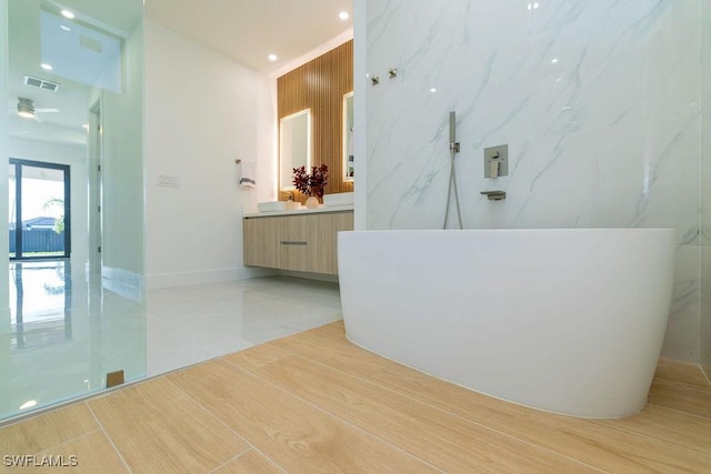 bathroom with tile patterned floors, a shower, and vanity