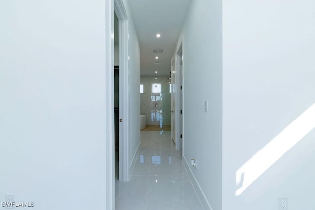 hall with light tile patterned floors