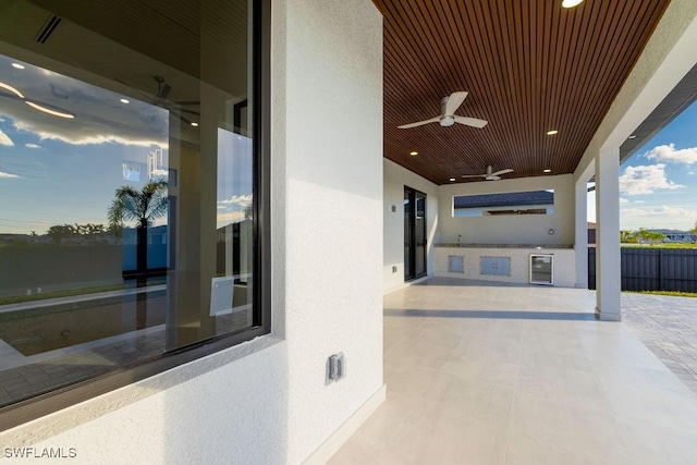 view of patio featuring ceiling fan and exterior kitchen