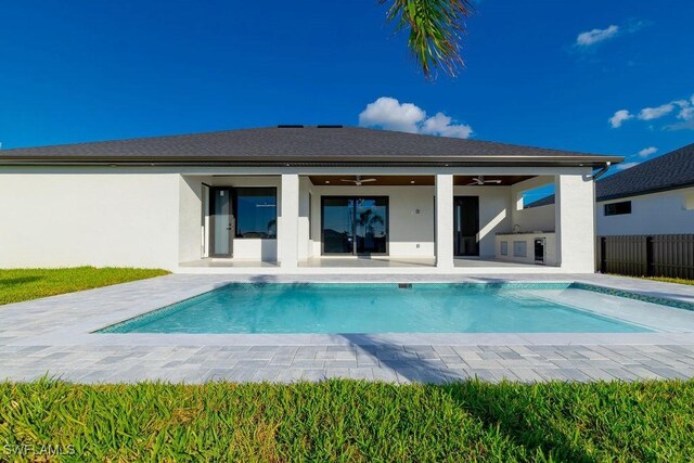 back of house with ceiling fan, a patio, and an outdoor kitchen