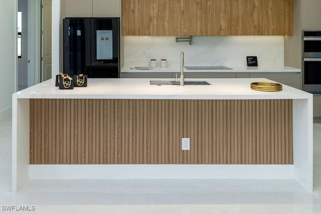 kitchen featuring light tile patterned floors, sink, and black appliances