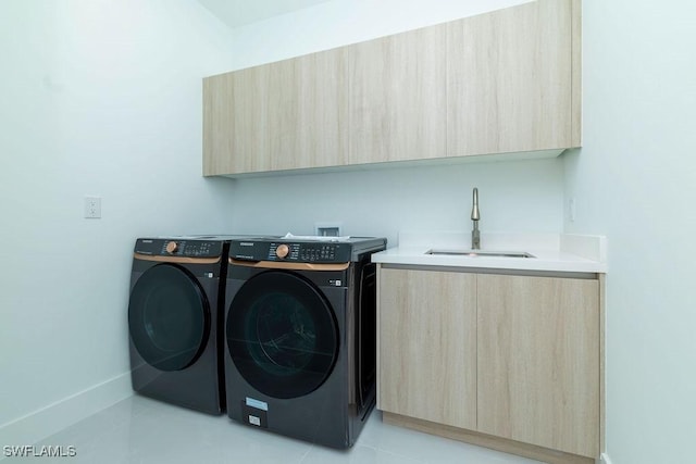 laundry room with separate washer and dryer, sink, and cabinets