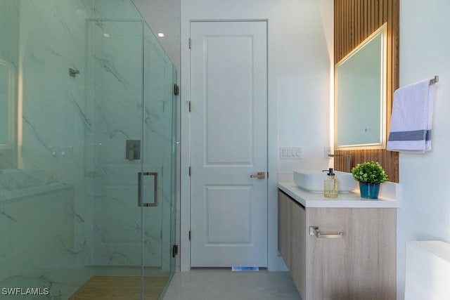 bathroom with vanity, toilet, and a shower with door