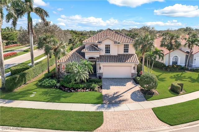 mediterranean / spanish-style house with a garage and a front yard