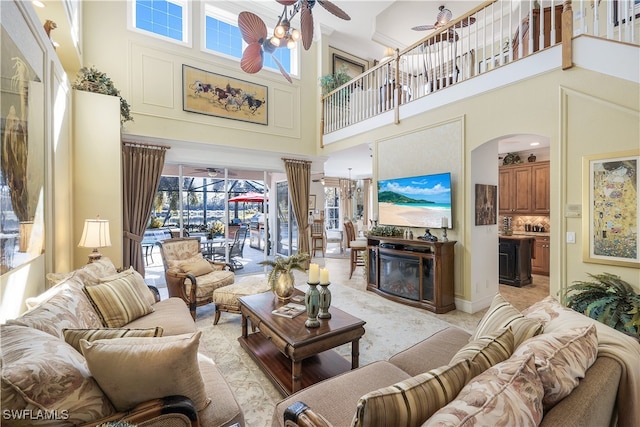 living room featuring a high ceiling and a wealth of natural light