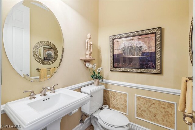 bathroom with toilet and sink