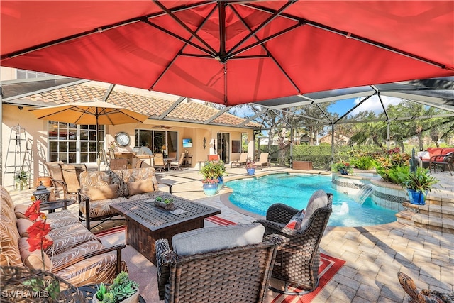 view of swimming pool featuring outdoor lounge area, a hot tub, glass enclosure, a patio, and pool water feature