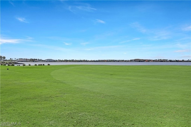 view of property's community featuring a water view and a lawn