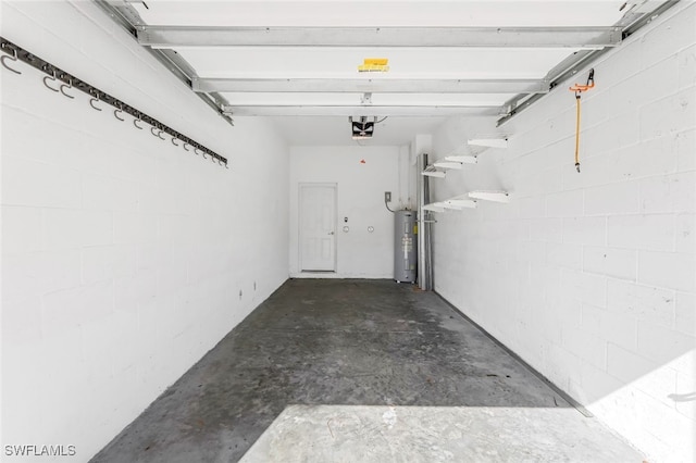 garage featuring electric water heater and a garage door opener