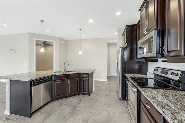 kitchen with hanging light fixtures, dark brown cabinets, sink, and appliances with stainless steel finishes