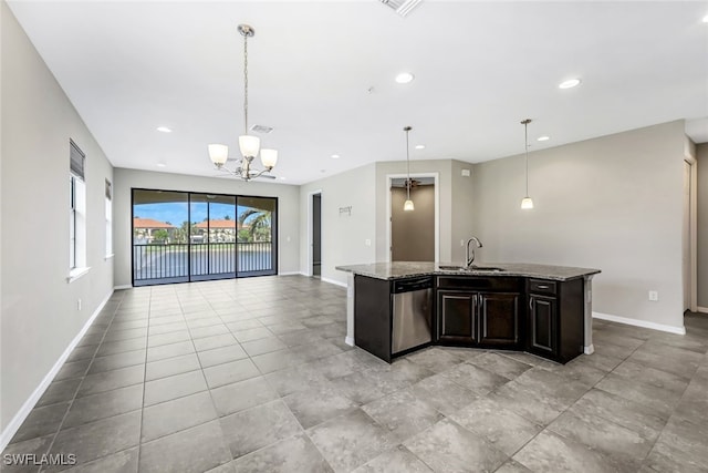 kitchen featuring dishwasher, light stone countertops, pendant lighting, and sink