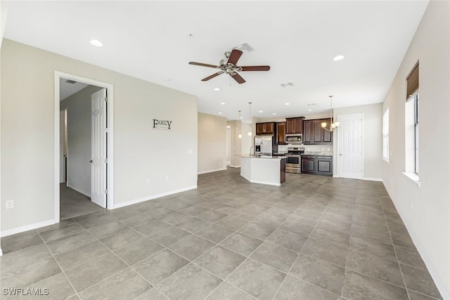 unfurnished living room featuring ceiling fan and light tile patterned floors