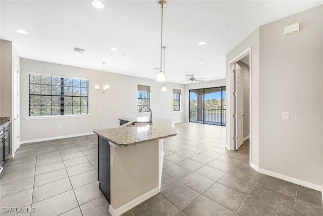 kitchen featuring pendant lighting, sink, ceiling fan with notable chandelier, and plenty of natural light