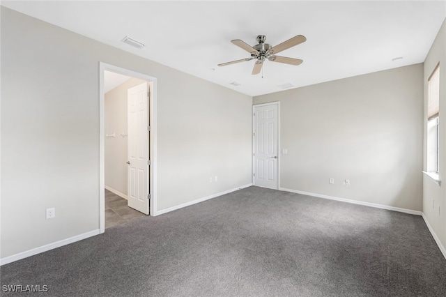 carpeted spare room with ceiling fan