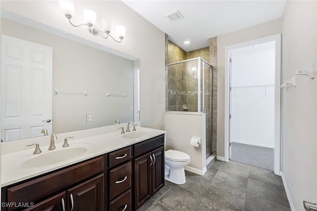 bathroom featuring an enclosed shower, vanity, tile patterned floors, and toilet