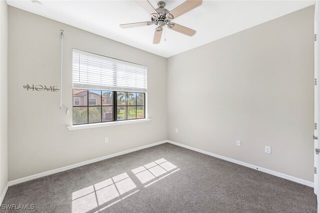 carpeted spare room featuring ceiling fan