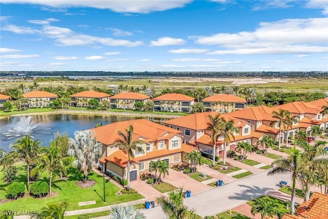 drone / aerial view with a residential view and a water view