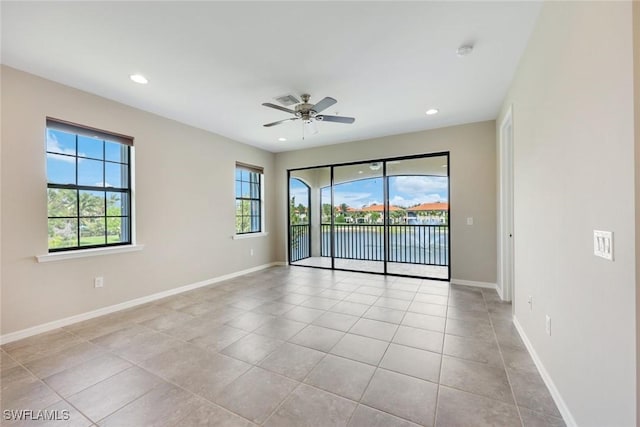 spare room with a ceiling fan, recessed lighting, and baseboards