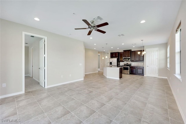 unfurnished living room with recessed lighting, visible vents, and baseboards