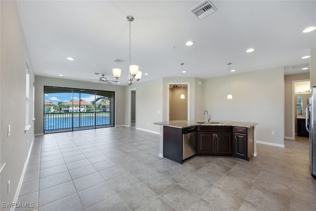 kitchen featuring a center island with sink, stainless steel appliances, visible vents, open floor plan, and a sink