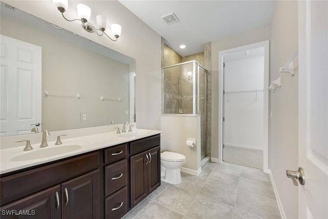 bathroom featuring double vanity, a stall shower, visible vents, and a sink