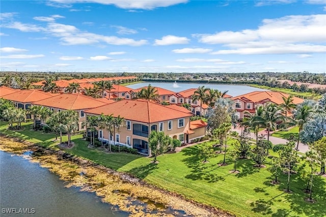 birds eye view of property with a water view and a residential view