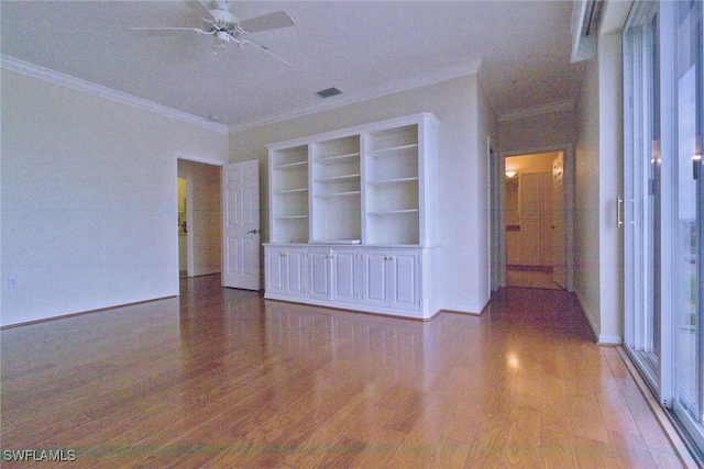 empty room featuring hardwood / wood-style flooring, ceiling fan, and crown molding