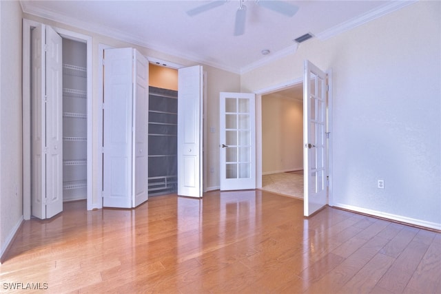 unfurnished bedroom featuring french doors, hardwood / wood-style floors, ornamental molding, and ceiling fan