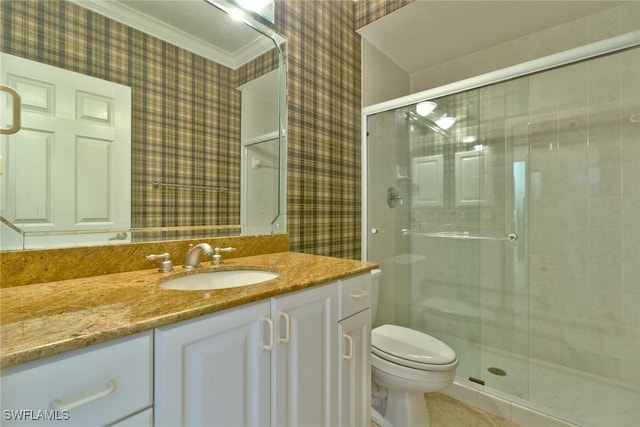 bathroom with vanity, toilet, an enclosed shower, and crown molding