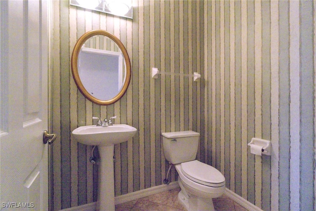 bathroom with tile patterned flooring, sink, and toilet