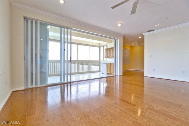 empty room with light wood-type flooring, ceiling fan, and crown molding