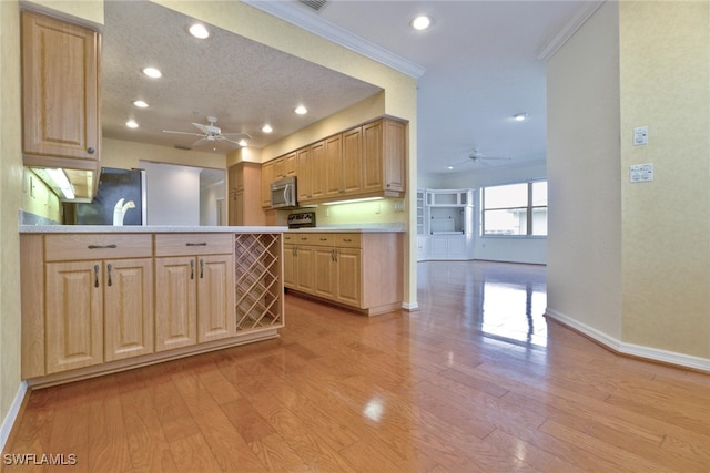 kitchen with refrigerator, kitchen peninsula, ornamental molding, light brown cabinets, and light hardwood / wood-style flooring