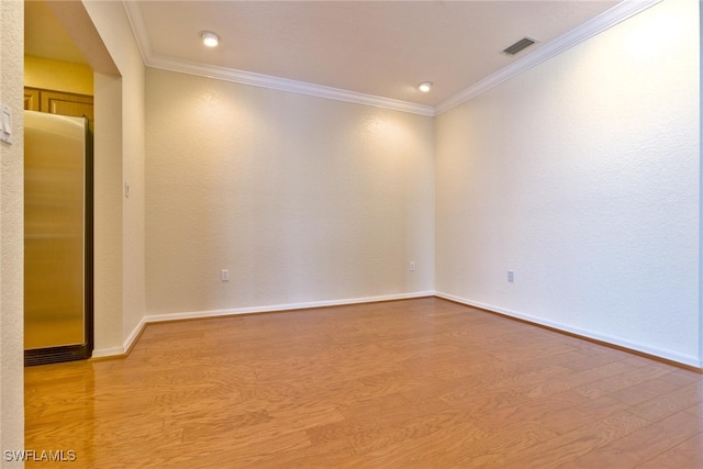 spare room with hardwood / wood-style flooring and ornamental molding