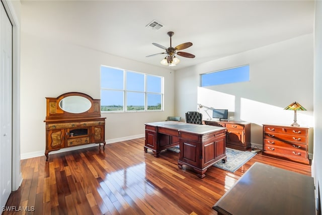 home office featuring dark wood-type flooring and ceiling fan