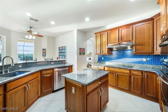 kitchen with dishwasher, dark stone counters, sink, and black electric stovetop