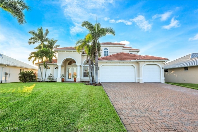 mediterranean / spanish-style home with a garage and a front yard