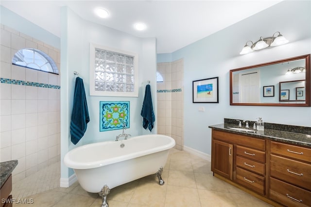 bathroom with plus walk in shower, vanity, and tile patterned flooring