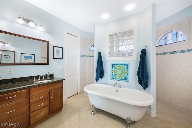 bathroom with tile patterned flooring, vanity, and separate shower and tub