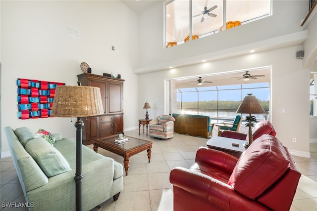 living room featuring light tile patterned flooring and a high ceiling