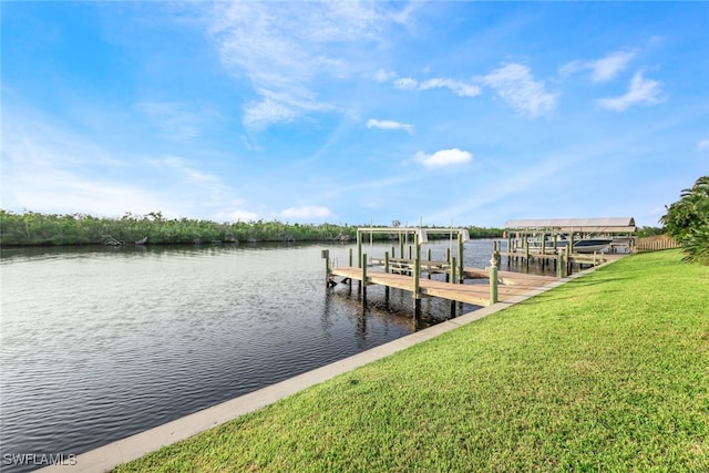 view of dock with a lawn and a water view