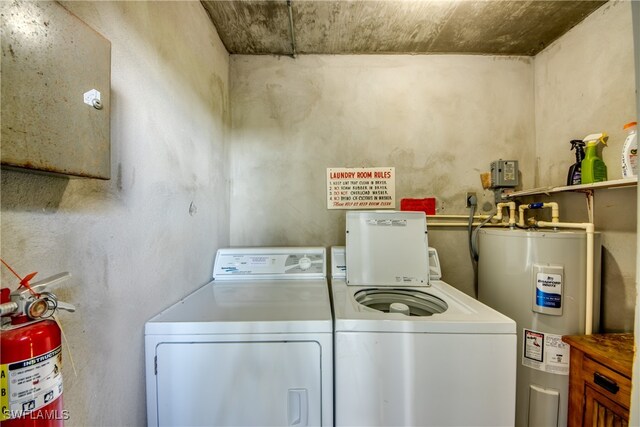 clothes washing area featuring washing machine and dryer and electric water heater