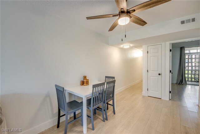 dining area featuring light hardwood / wood-style flooring and ceiling fan