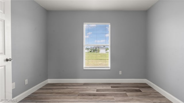 spare room with hardwood / wood-style flooring