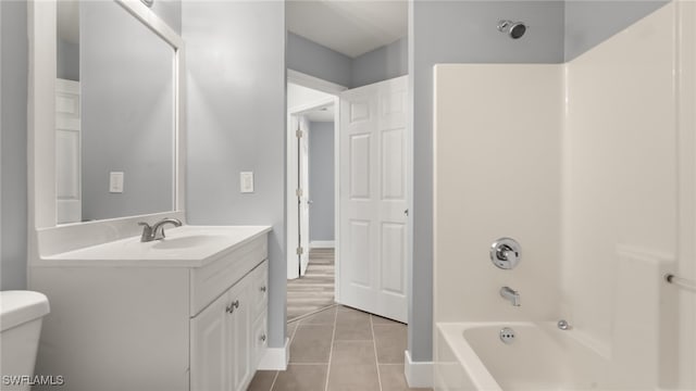 full bathroom with vanity, shower / tub combination, tile patterned flooring, and toilet