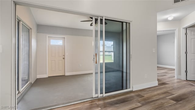 spare room with plenty of natural light, dark wood-type flooring, and ceiling fan