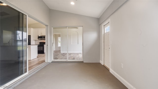 unfurnished room with lofted ceiling and wood-type flooring